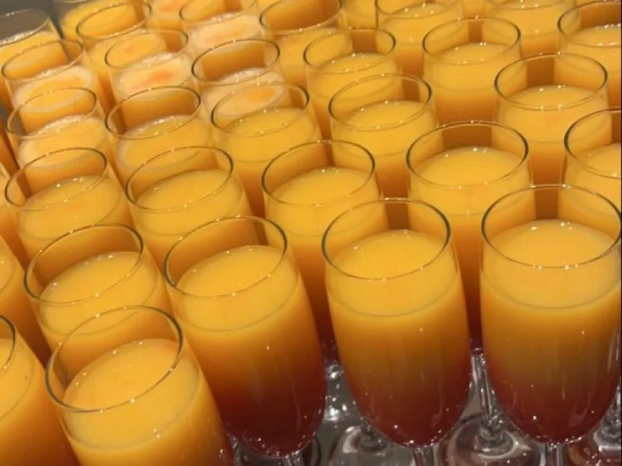 Chilled mango juice served in glasses for guests