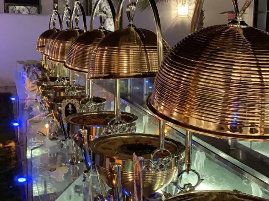 Copper-domed chafing dishes set out for an evening family gathering