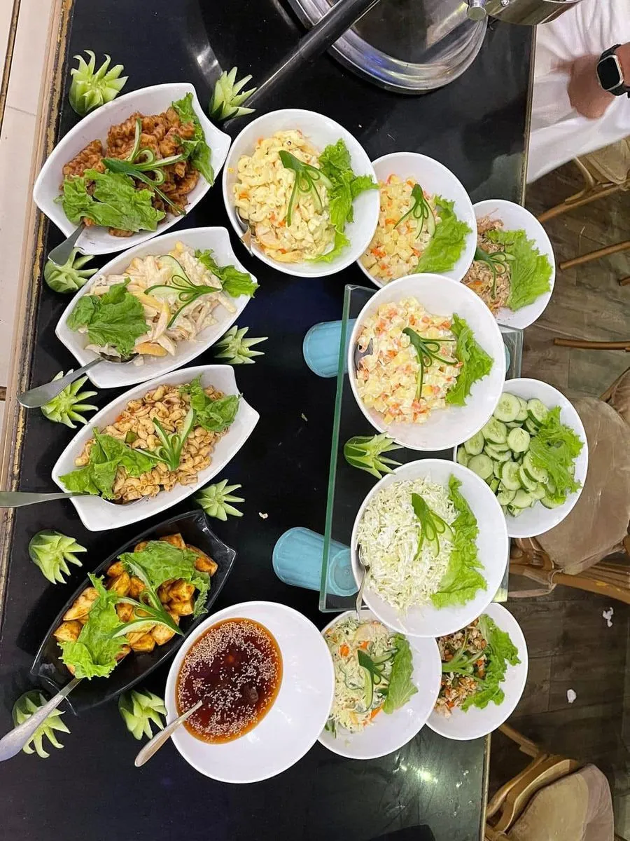 A spread of fresh salads and sides arranged for a buffet